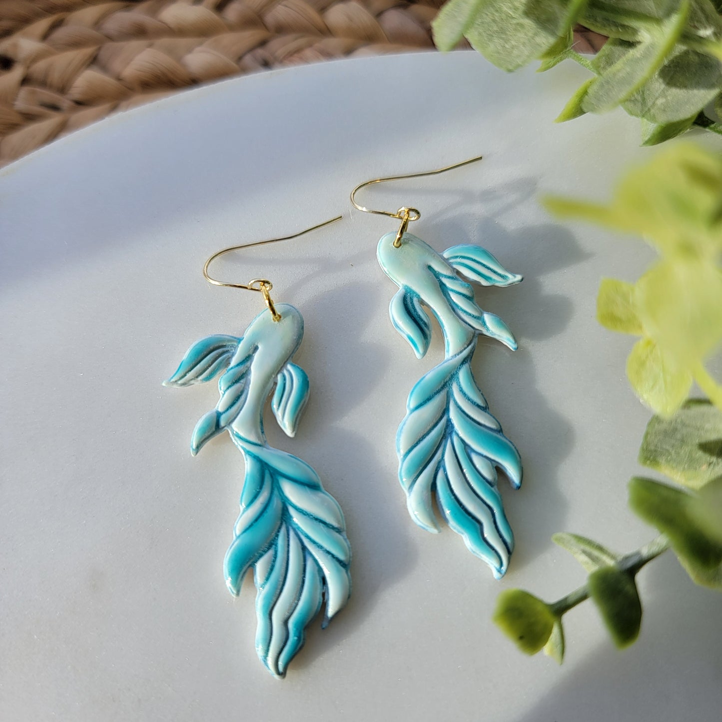 Koi fish earrings in a mix of blues and greens.