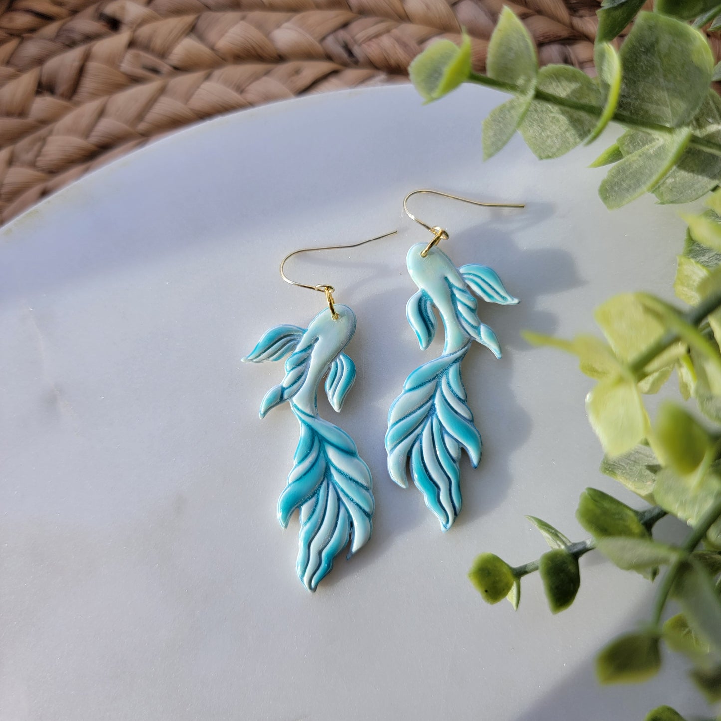 Koi fish earrings in a mix of blues and greens.
