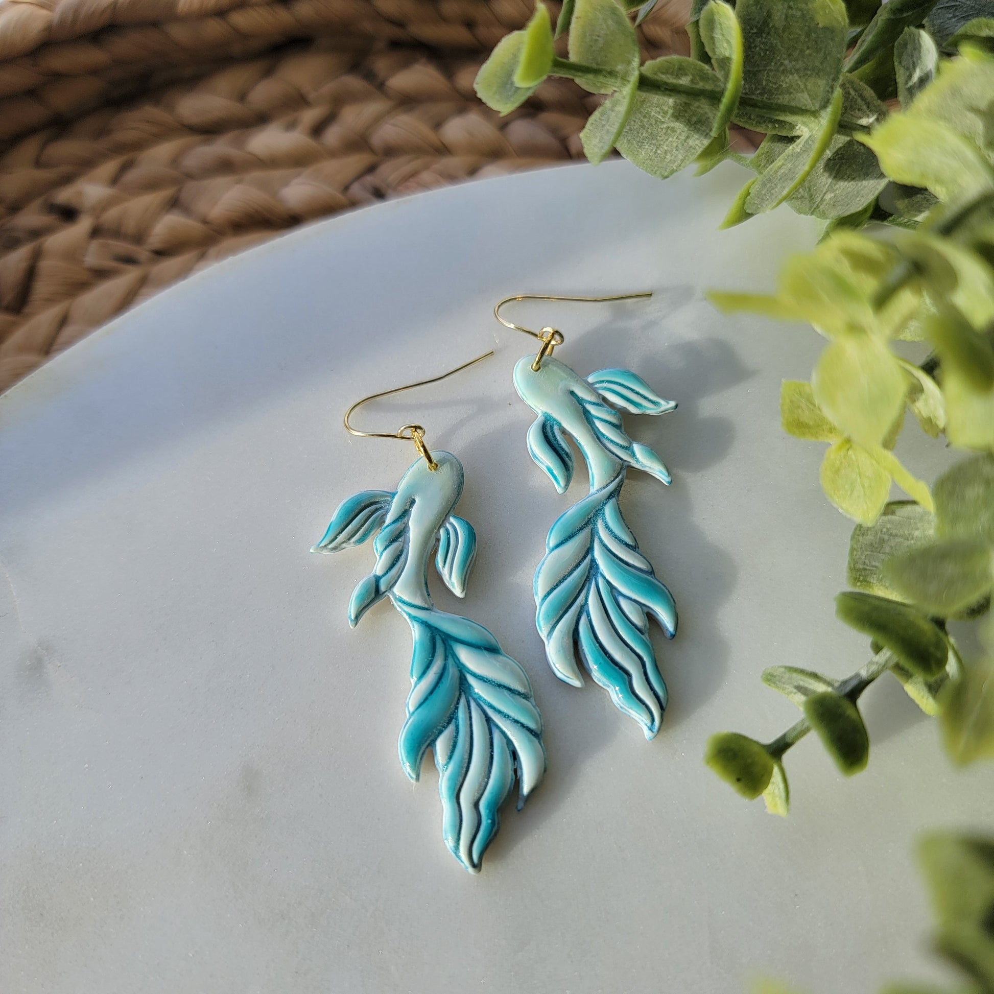 Koi fish earrings in a mix of blues and greens.
