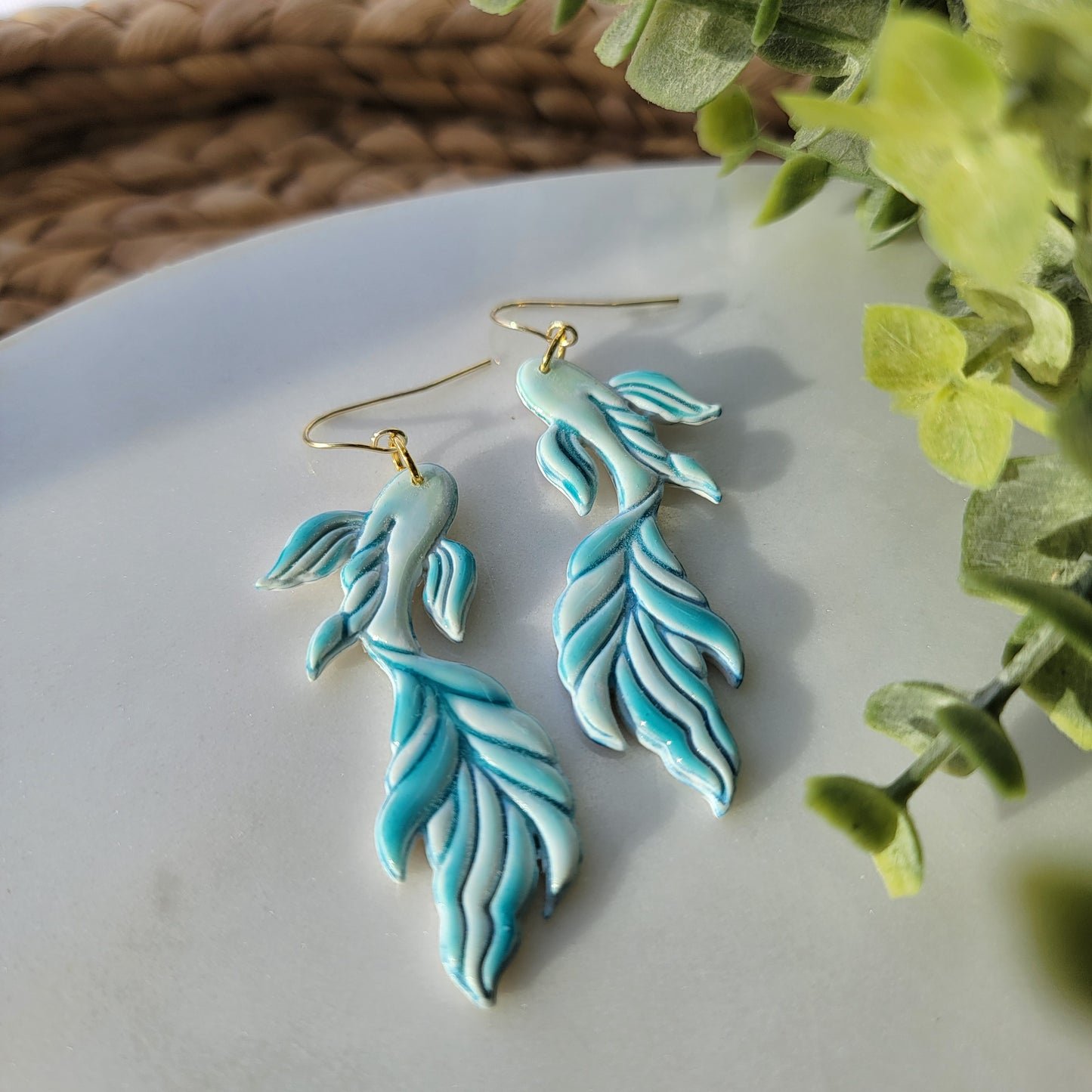 Koi fish earrings in a mix of blues and greens.