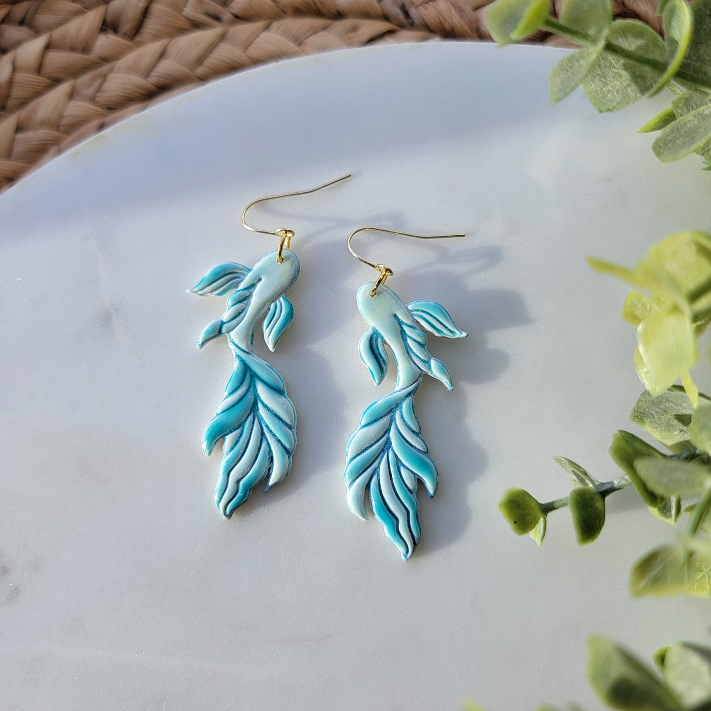 Koi fish earrings in a mix of blues and greens.