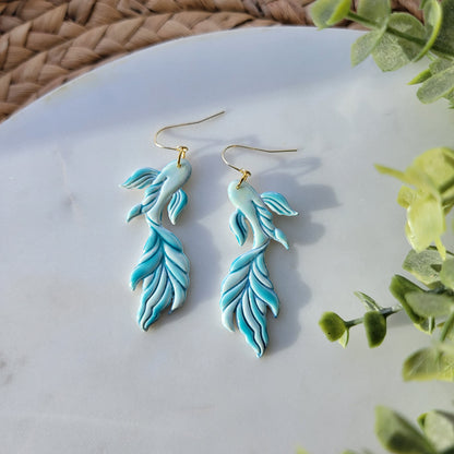 Koi fish earrings in a mix of blues and greens.